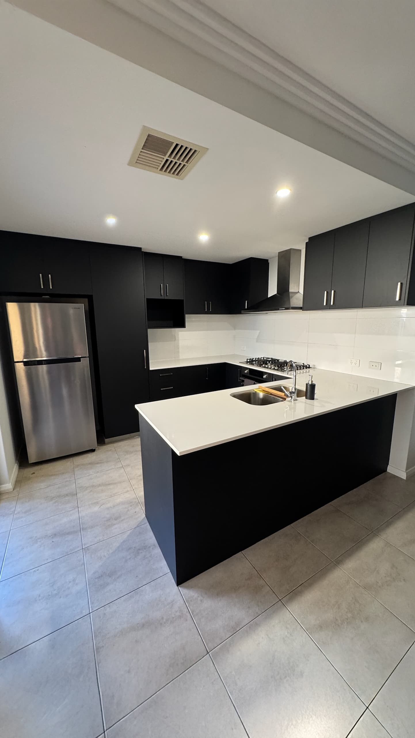 Cream gloss kitchen refreshed in matte black wrap
